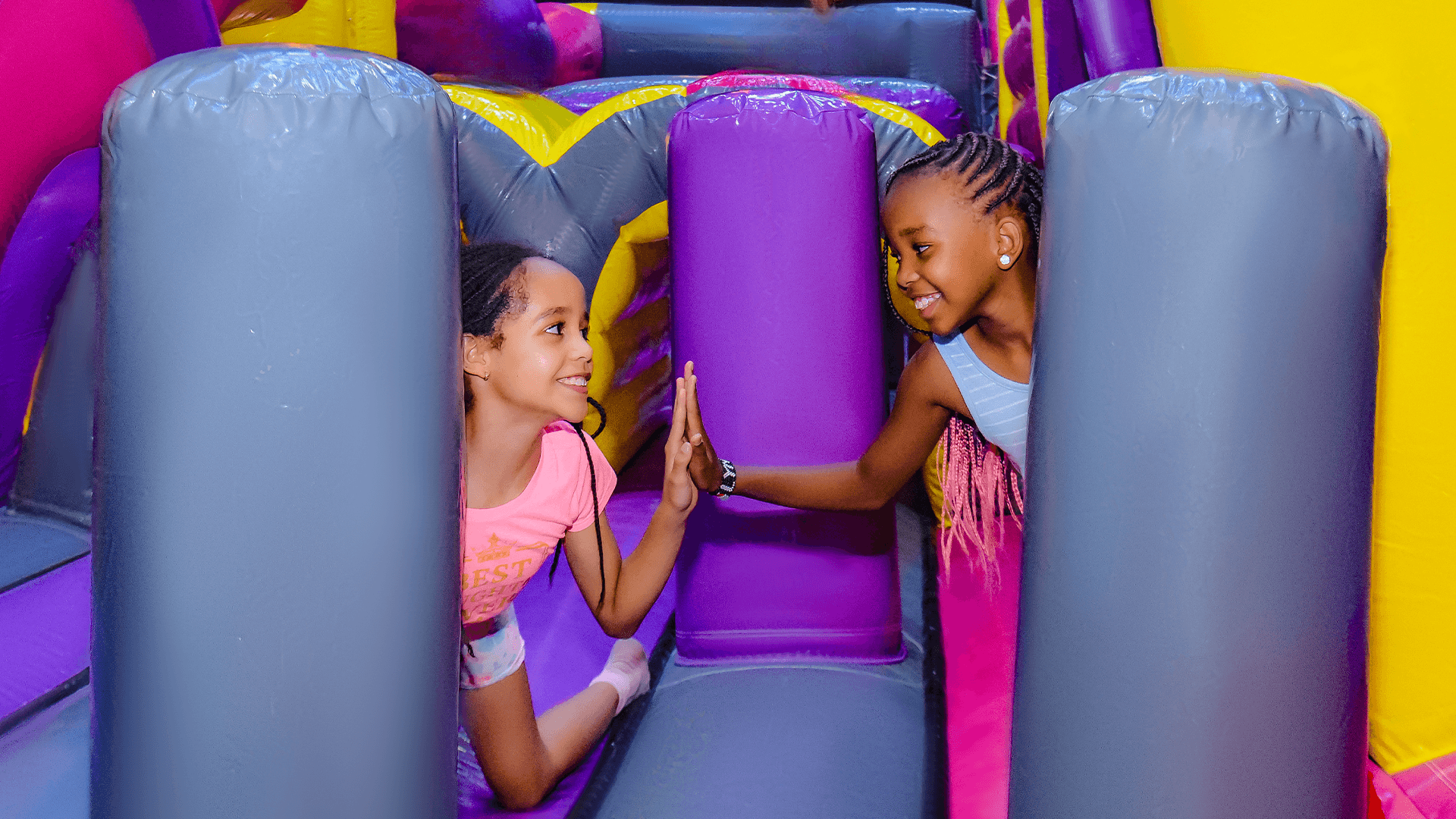 Children enjoying aerial play in the Air Park zone at The Hub Park, an indoor trampoline bounce park near Nairobi.