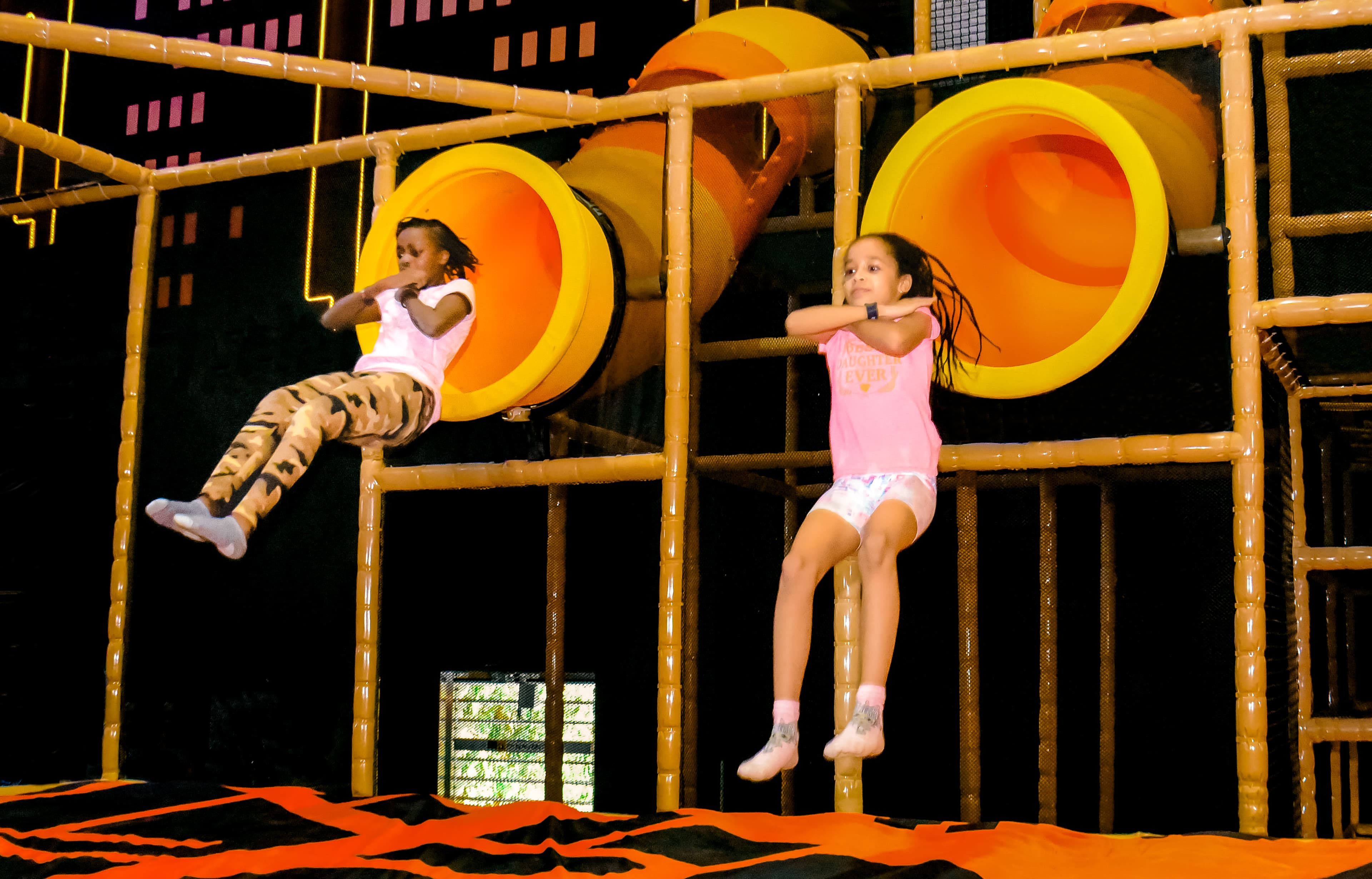Guest landing on Bag Jump at The Hub Park, a bounce place and game center near me with fun zones for all.