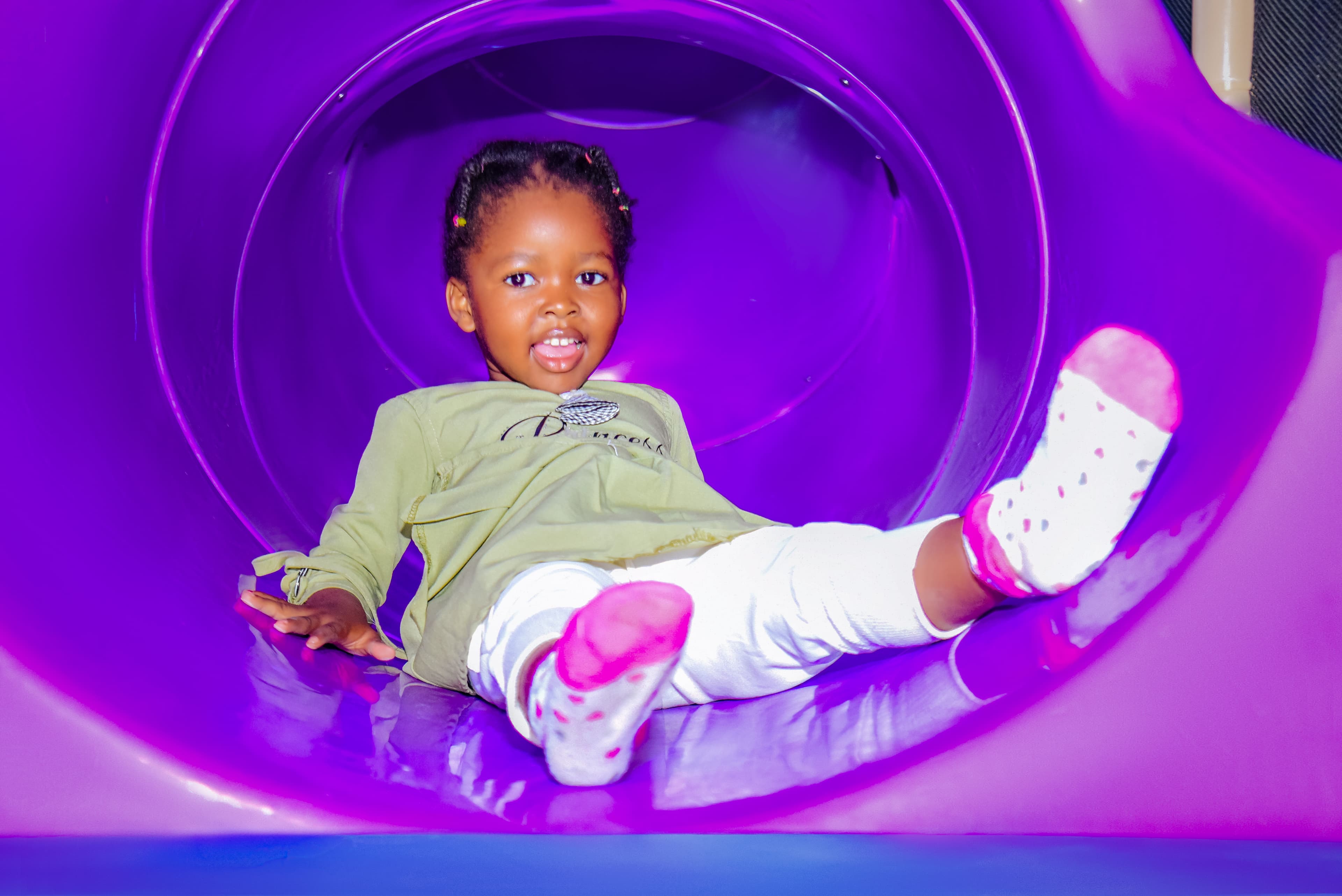 Smiling toddler enjoying safe and fun activities at The Hub Park, a happy family fun center and indoor play arena.