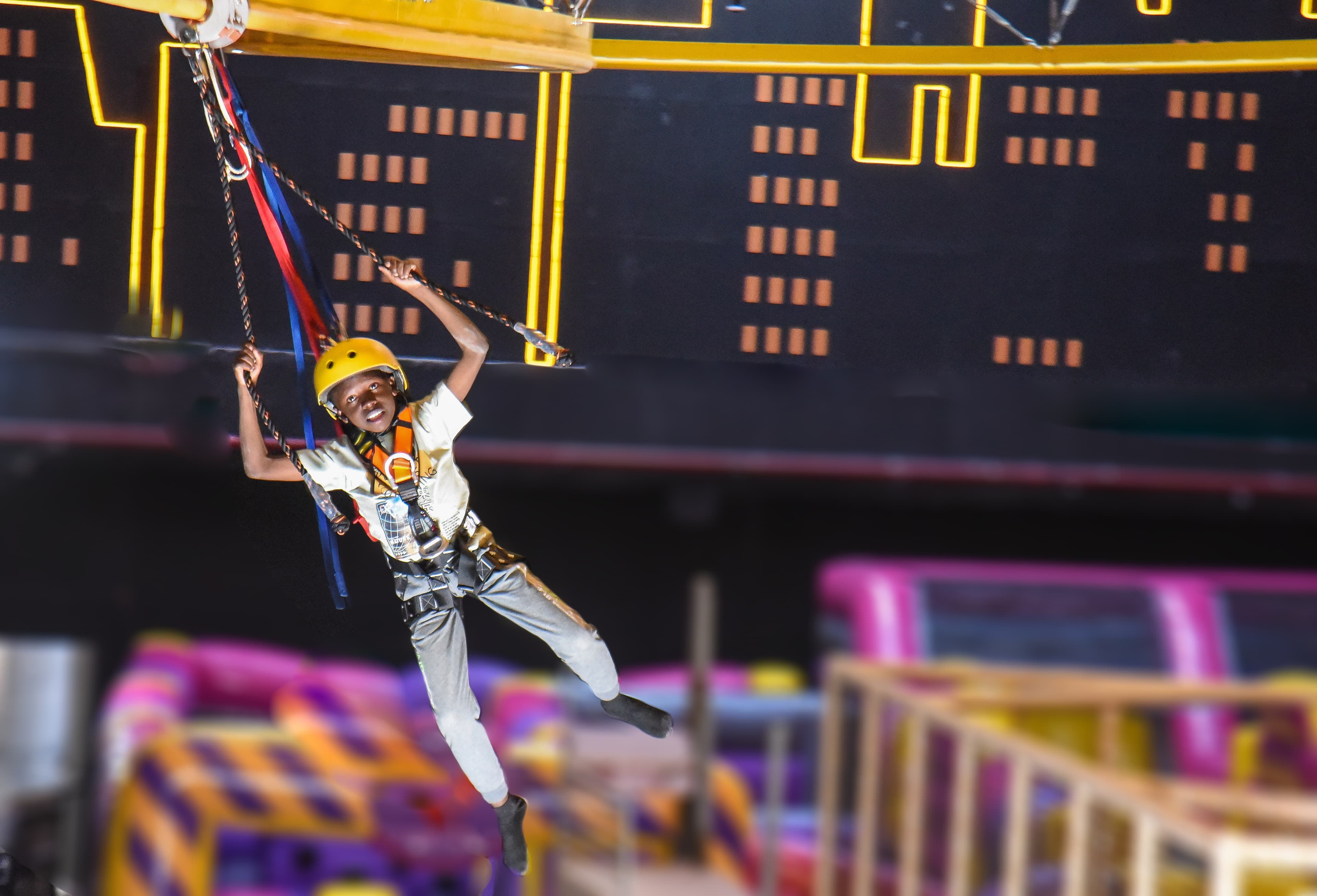 Visitor gliding through the Aerial Glider at The Hub Park, a bounce bounce attraction at Nairobi's funland.